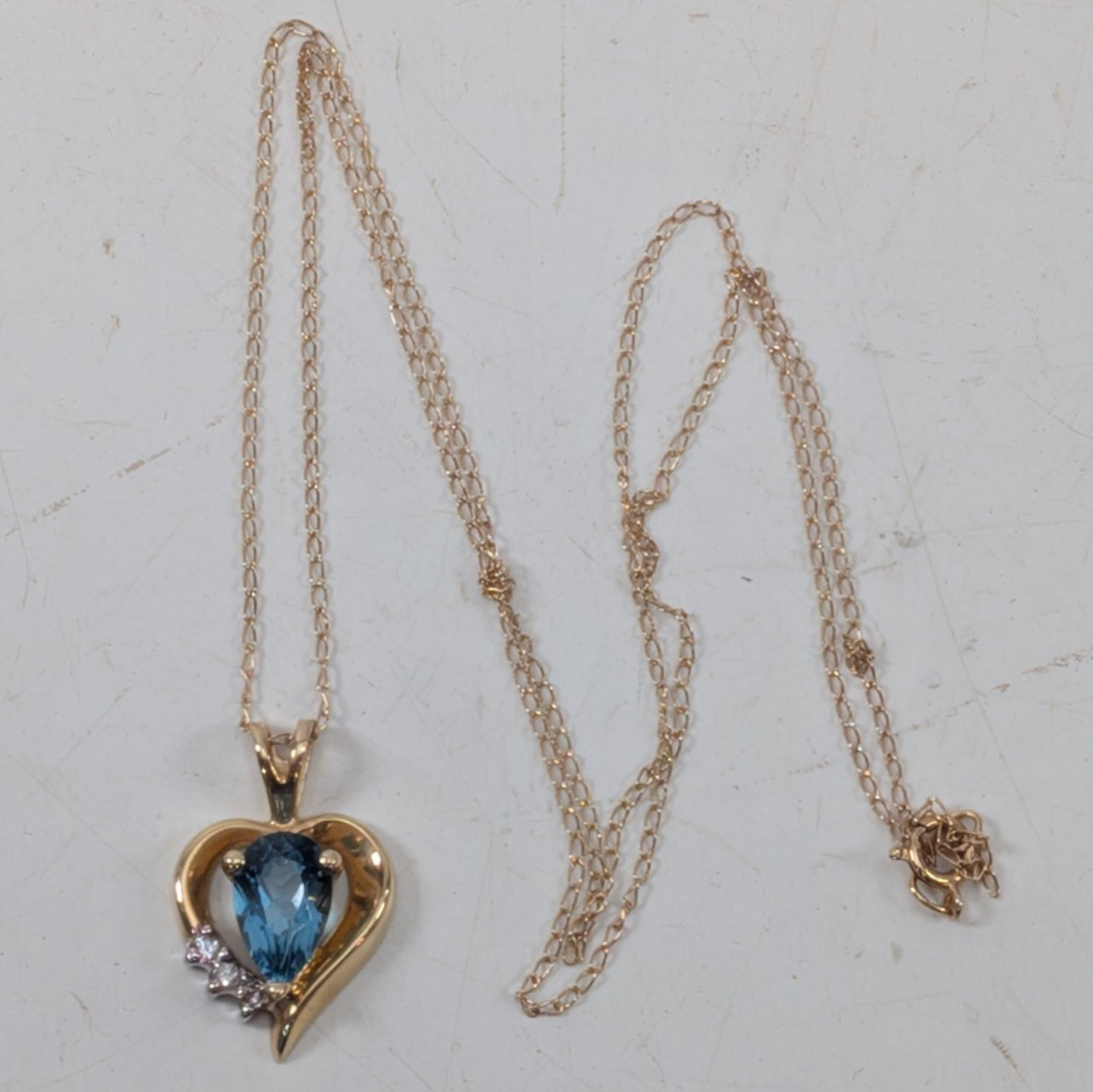 14K Yellow Gold Heart Necklace w/ (1) Blue Stone & (3) Clear Stone Accents